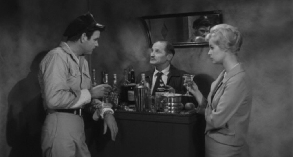 A scene featuring three characters: a man in a military shirt holding a drink, a man in a suit behind a bar with various bottles, and a woman in a tailored outfit holding a glass, all set in a smoky environment.