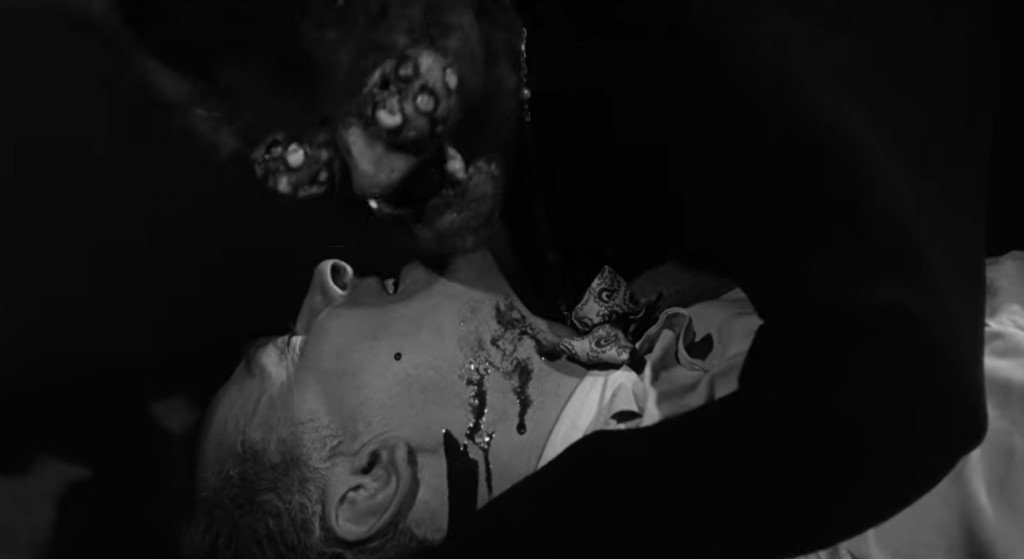 A black and white scene depicting a creature with octopus-like features attacking a person lying on the ground, with visible distress on the person's face.